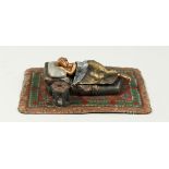 A VIENNA STYLE COLD PAINTED BRONZE OF A SLEEPING WOMAN on a Persian rug. 6ins long.