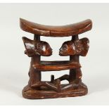 A CHUCKWAY TRIBAL CARVED WOOD HEAD REST 6.5ins high.