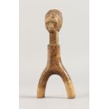 AN AFRICAN CARVED WOOD FIGURE. 8ins long