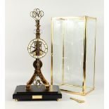 A GOOD REPRODUCTION "SKELETON SCISSOR CLOCK" housed in a glazed case. 23ins high.