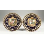 A SUPERB PAIR OF VIENNA PIERCED EDGE BLUE AND GILT PLATES, the centre painted with young lovers.