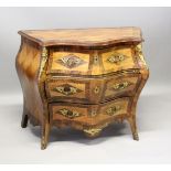 A GOOD SERPENTINE FRONTED BOMBE COMMODE, with cross banded top three long drawers with ormolu mounts