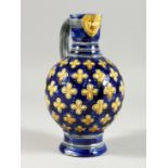 A MINTON MAJOLICA BLUE GROUND VASE with mask spout. 8ins high.