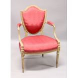A GEORGE III SHIELD BACK ARM CHAIR with padded back arms and seat on turned fluted legs.