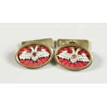 A PAIR OF RUSSIAN AND ENAMEL CUFF LINKS with Faberge mark.
