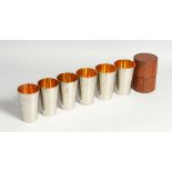 SIX GRADUATED DRINKING BEAKERS in a leather case.