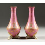 A SMALL PAIR OF SEVRES PINK GROUND VASES with gilt and pierced work. Mark in blue A.M. 6ins high