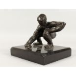 JUGANDO CANICAS (MEXICAN) A BRONZE CROUCHING MAN. Signed, on a black marble base. 5ins high.