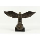 A BRONZE NATIVE EAGLE on a marble base. 17ins wide.