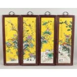 A SET OF FOUR CHINESE FRAMED PORCELAIN PLAQUES. 29ins long 8ins wide.