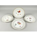 A SET OF FOUR MEISSEN WHITE GROUND PIERCED PLATES of raised lattice design and painted flowers.