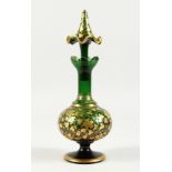 A BOHEMIAN GREEN AND GILT DECANTER AND STOPPER 10.5 ins high.