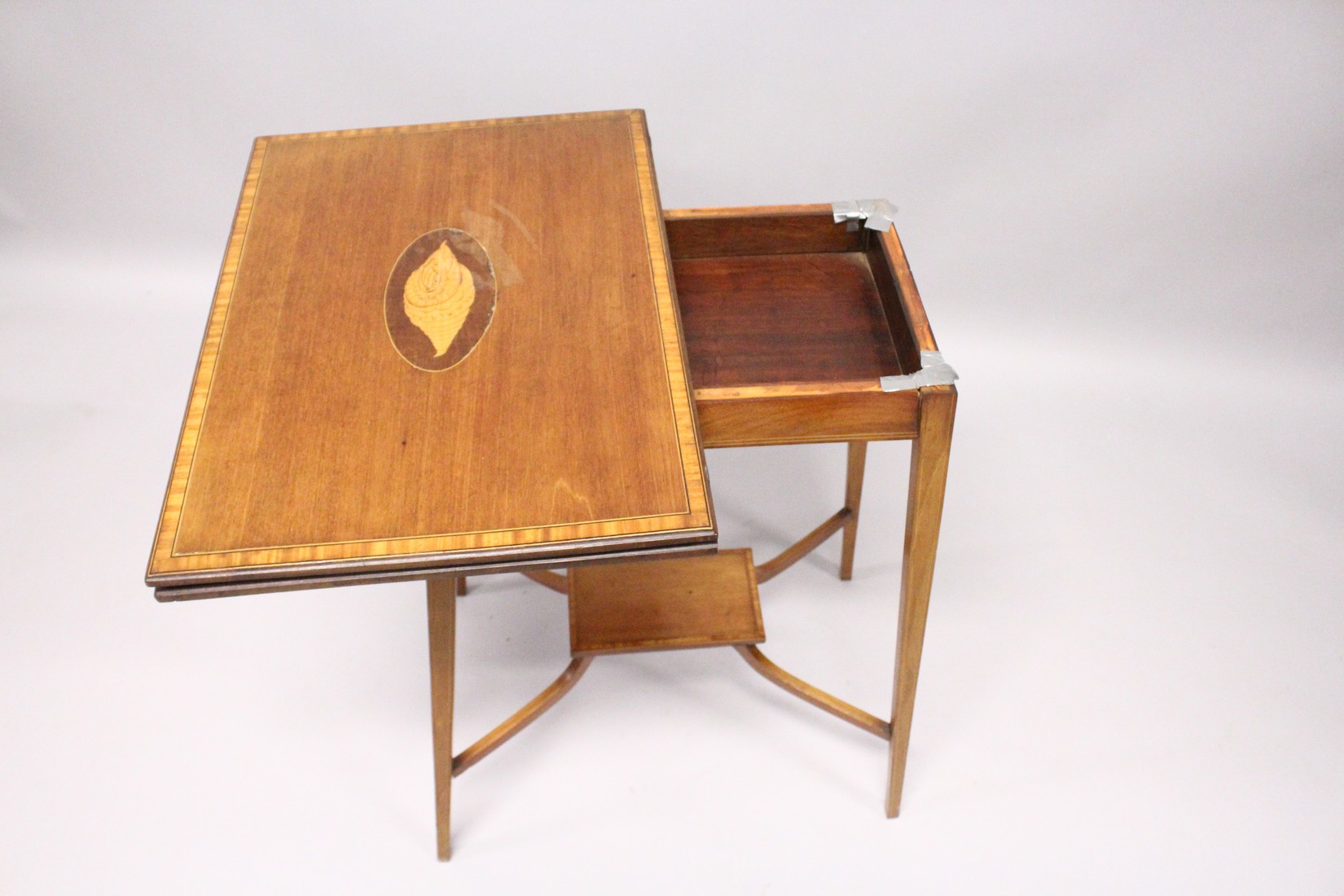 AN EDWARDIAN MAHOGANY FOLDING TOP TEA TABLE, on tapering legs with under tier. 1ft 9ins long. - Image 4 of 5