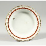 A BRISTOL SMALL PLATE decorated with two random leaves, a burnt orange around the border entwined