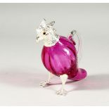A PINK PARROT JUG with plated head and feet.