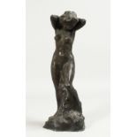 A BRONZE STANDING NUDE. 12ins high.