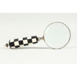 A MAGNIFYING GLASS WITH CHEQUERED HANDLE