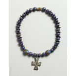 A ROMAN BEAD BRACELET with crucifix pendant.