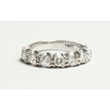 AN 18CT GOLD SIX STONE DIAMOND RING.