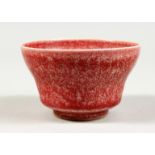 A SMALL CHINESE SPECKLED RED PORCELAIN BOWL. 3.5ins diameter.