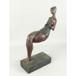 AN ABSTRACT BRONZE SEATED LADY on a rectangular base. 24ins high.