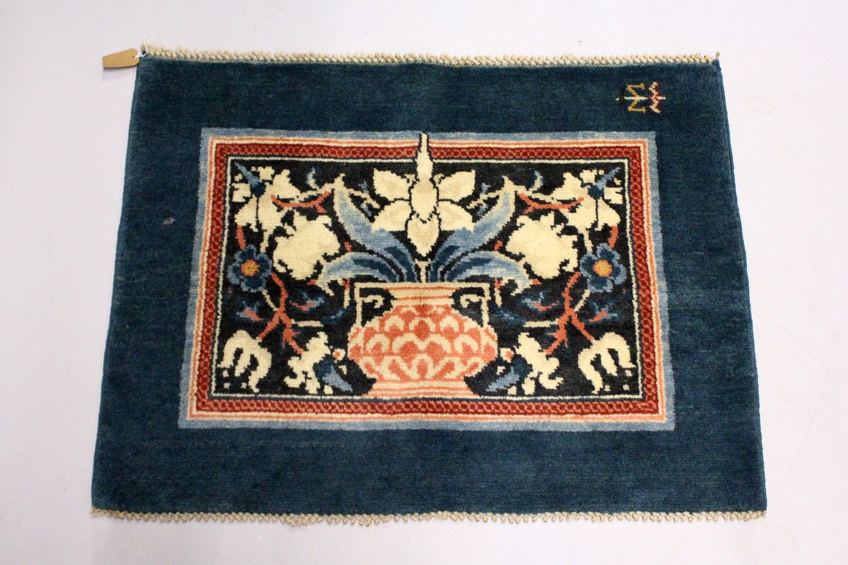 MORRIS & CO., HAMMERSMITH STUDIO, a small wool rug, blue ground, the central rectangular panel woven