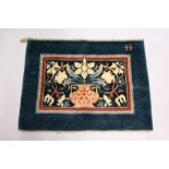 MORRIS & CO., HAMMERSMITH STUDIO, a small wool rug, blue ground, the central rectangular panel woven