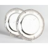 A PAIR OF GEORGE III CAST SILVER DINNER PLATES with gadrooned edges, 10 ins diameter, crested,
