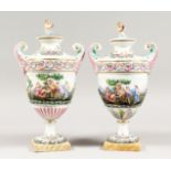 A GOOD PAIR OF CAPODIMONTE URN SHAPED, TWO HANDLED VASES AND COVERS with classical figures in relief