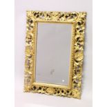 A GOOD 19TH CENTURY FLORENTINE GILT FRAMED RECTANGULAR MIRROR, the frame with well carved leaf and