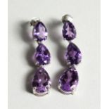 A PAIR OF SILVER THREE TIER AMETHYST DROP EAR RINGS