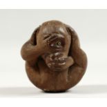 A JAPANESE CARVED WOOD MONKEY. Signed, 3ins high.