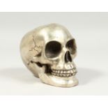 A SILVER PLATED BRONZE SKULL 5ins high