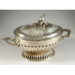 A LARGE CONTINENTAL SILVER TWO HANDLED OVAL TUREEN AND COVER, semi fluted with engraved