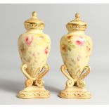 A PAIR OF GRAINGER &CO. ROYAL WORCESTER BLUSH IVORY URNS AND COVERS, painted with flowers on