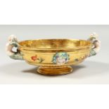 A GOOD BERLIN GILT GROUND OVAL BOWL with mermaid handles, masks and flowers. 8.5ins long