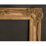 An early 20th century gilt composition frame, rebate size 18" x 32", 45.5 x 82 cm.