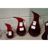 A graduated set of three Whitefriars red beak jugs.