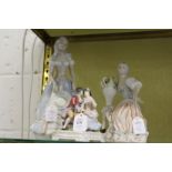 A continental porcelain group of two young lovers together with two Lladro style figures.