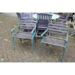 A pair of hardwood and metal garden armchairs.