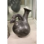 An early ram's head pottery vessel.