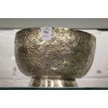 An eastern white metal bowl with embossed and engraved decoration.