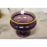 A good amethyst glass pedestal bowl with yellow edged rim and stem.
