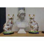 A pair of pottery cats and a Parian style bust of a young girl.