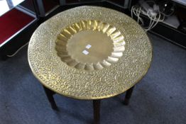 An eastern brass tray top table and stand.