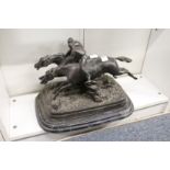 A cast spelter group of two jockeys on horseback (AF).