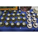 A large quantity of Denby cups and saucers and similar items.