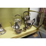 A good plated coffee pot, two kettles on stands and a three piece service.