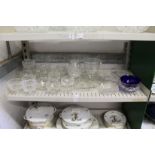 A shelf of cut glass sundae dishes and other items.