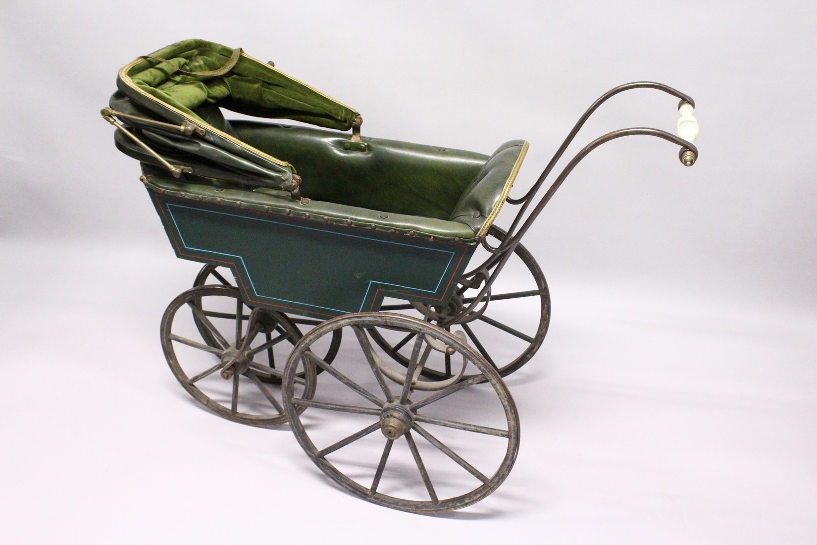 A RARE VICTORIAN METAL, WOOD AND LEATHER PRAM with folding hood, porcelain handles, wooden wheels. - Image 5 of 7